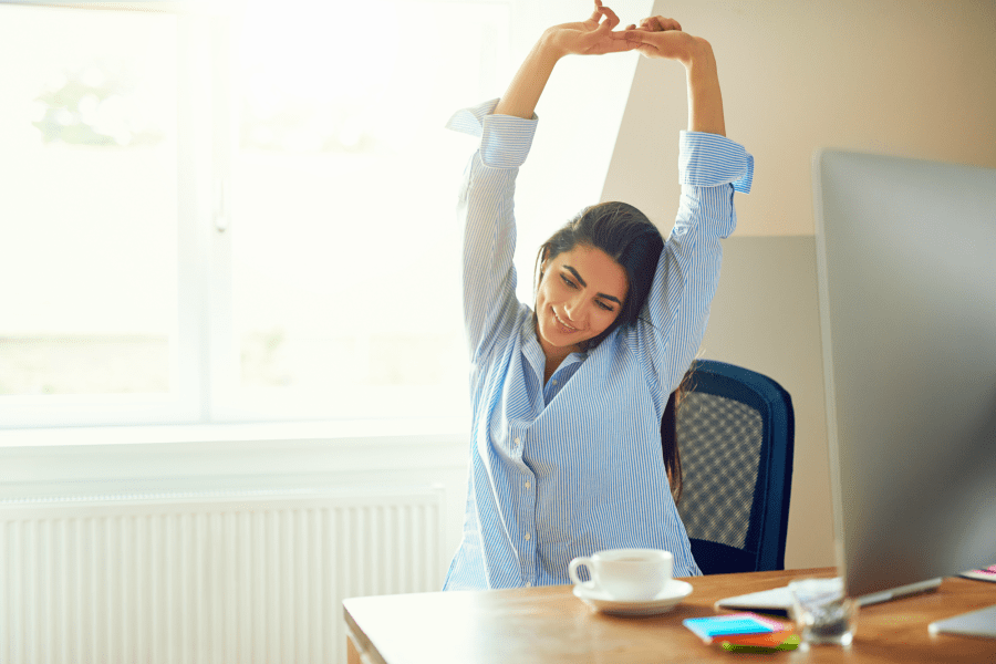 Person stretches at desk