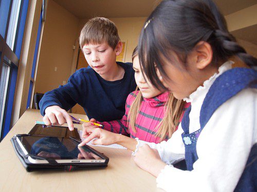 Students work on a tablet