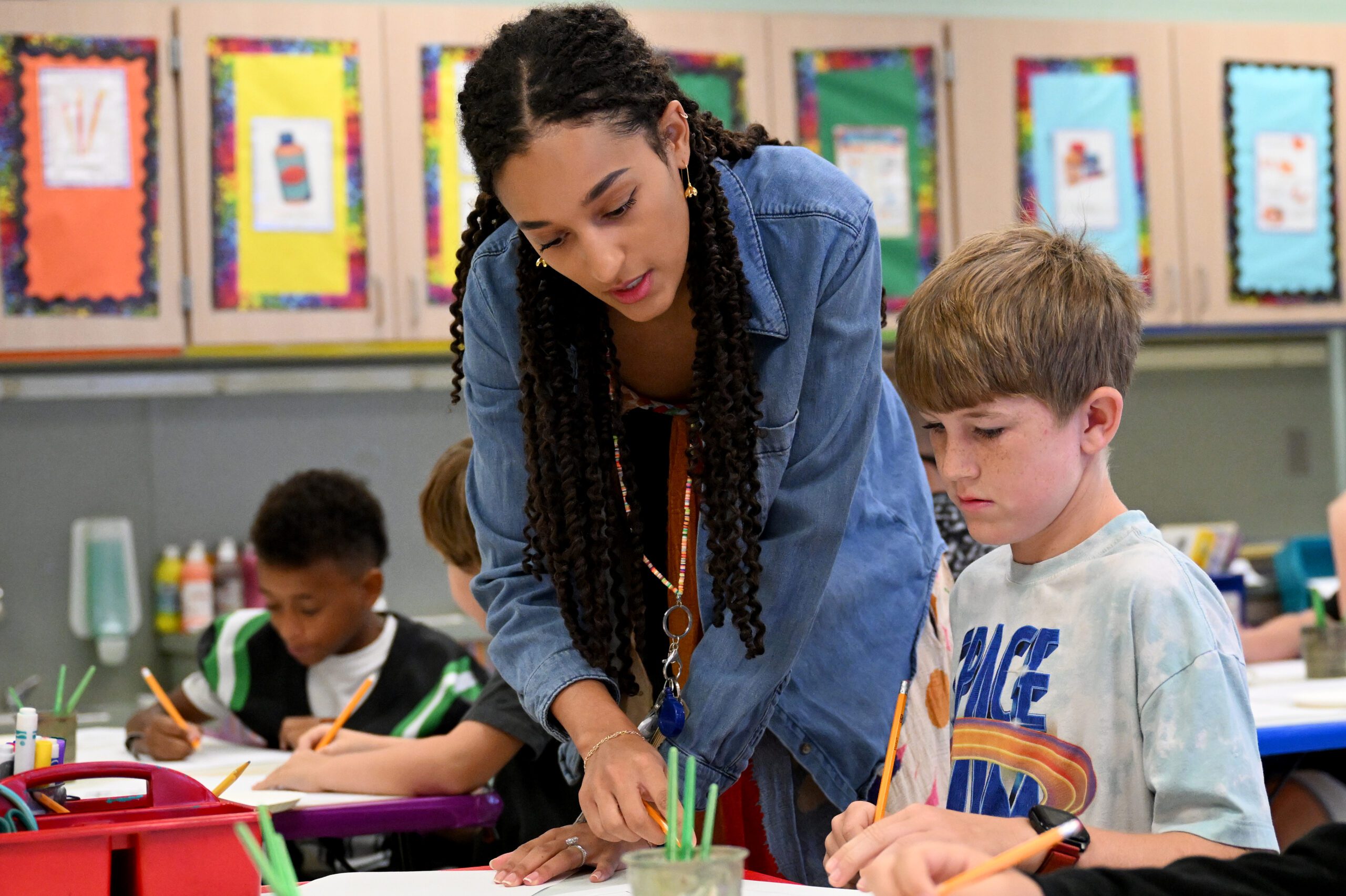 Teacher working with student